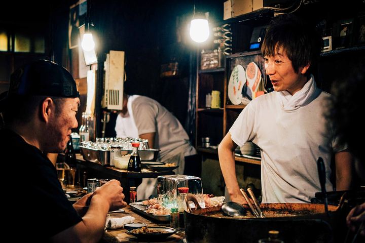 A busy restaurant counter at night