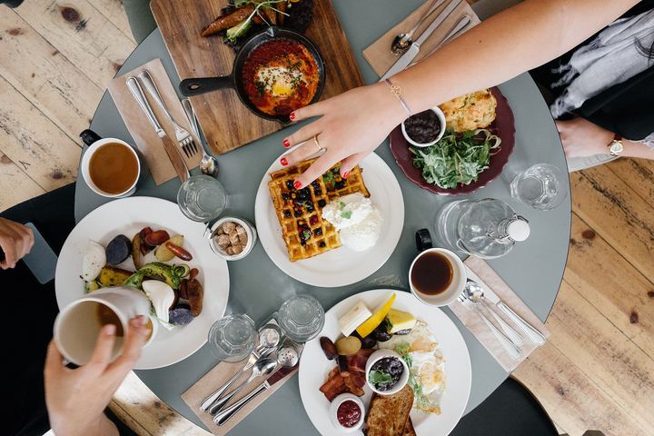 Friends sharing several dishes around one table